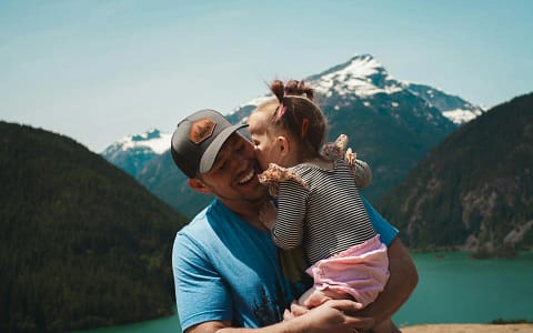 A Little Girl Giving her Dad a Kiss