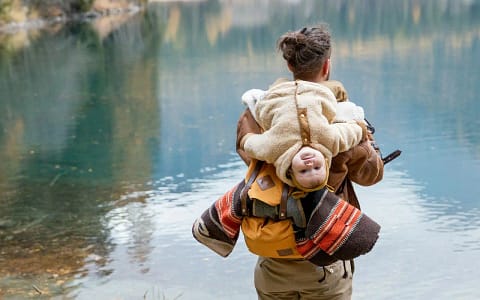 Photo Of Man Carrying Baby